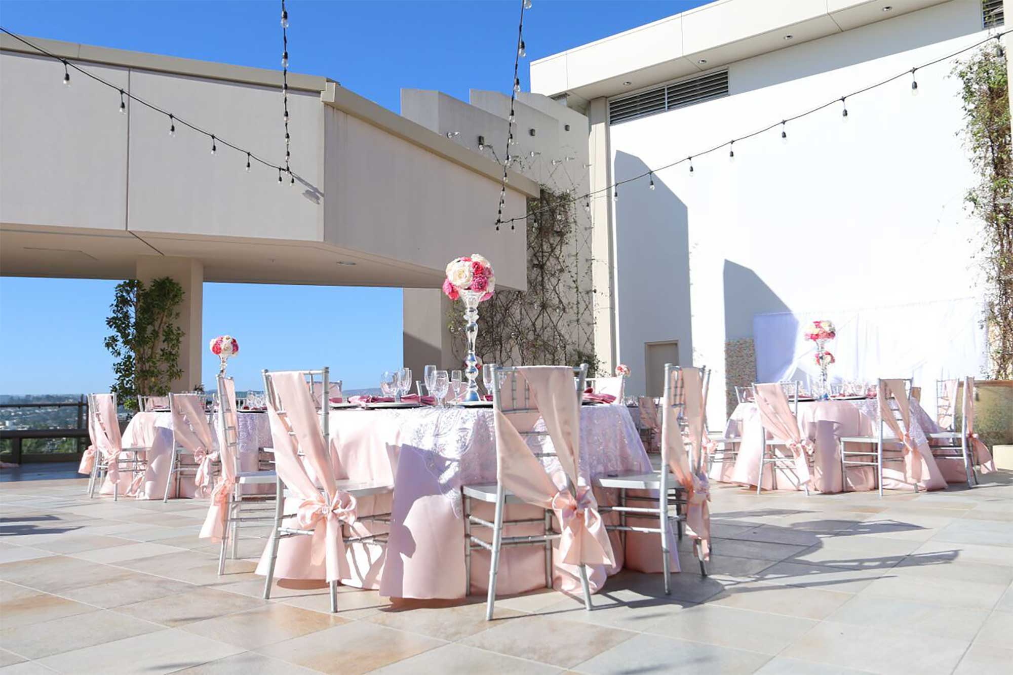 Starlight Terrace Corporate event venue in San Diego County set up with round tables and decorated in a pink and white theme