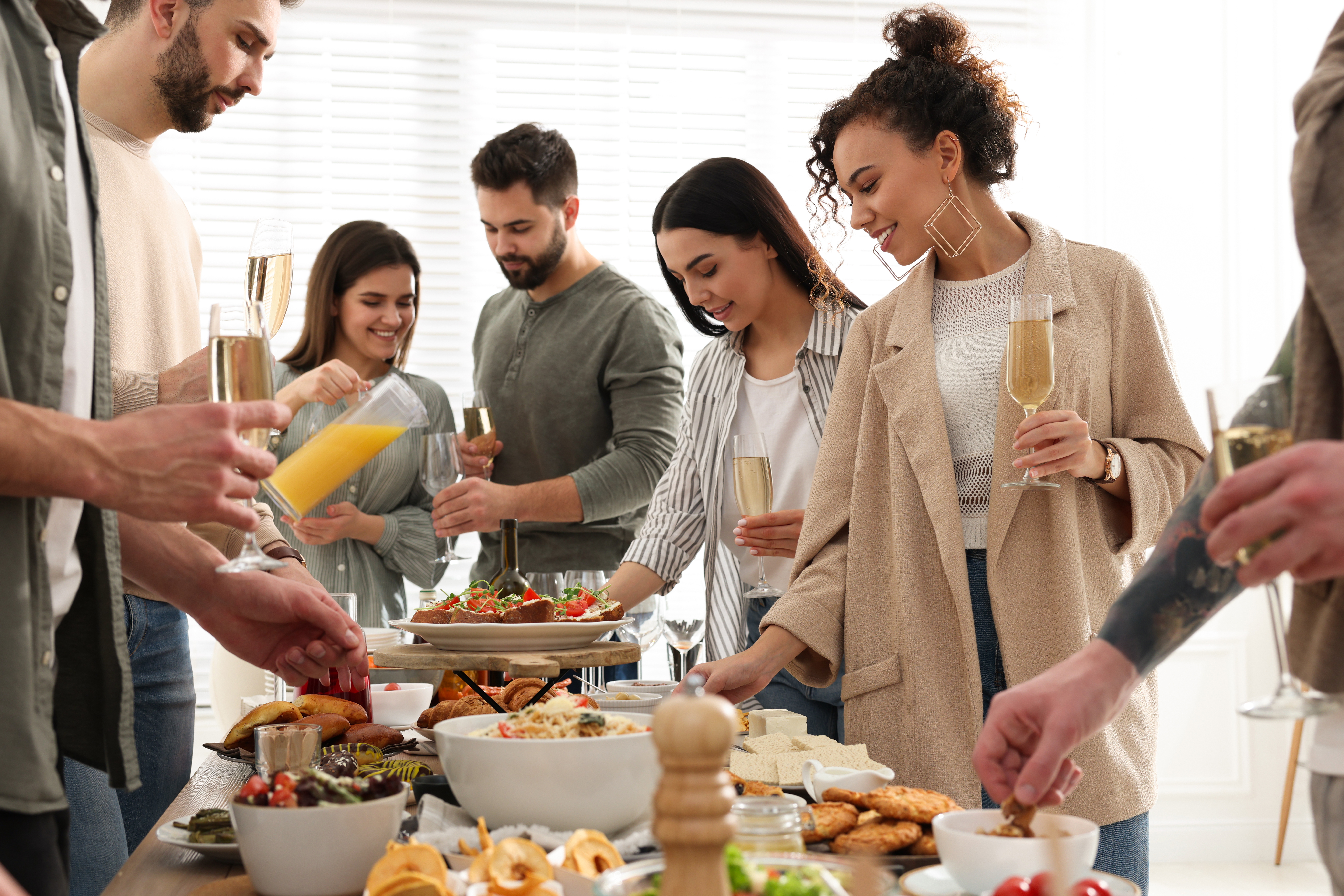 A group of people enjoying an indoor post wedding brunch together
