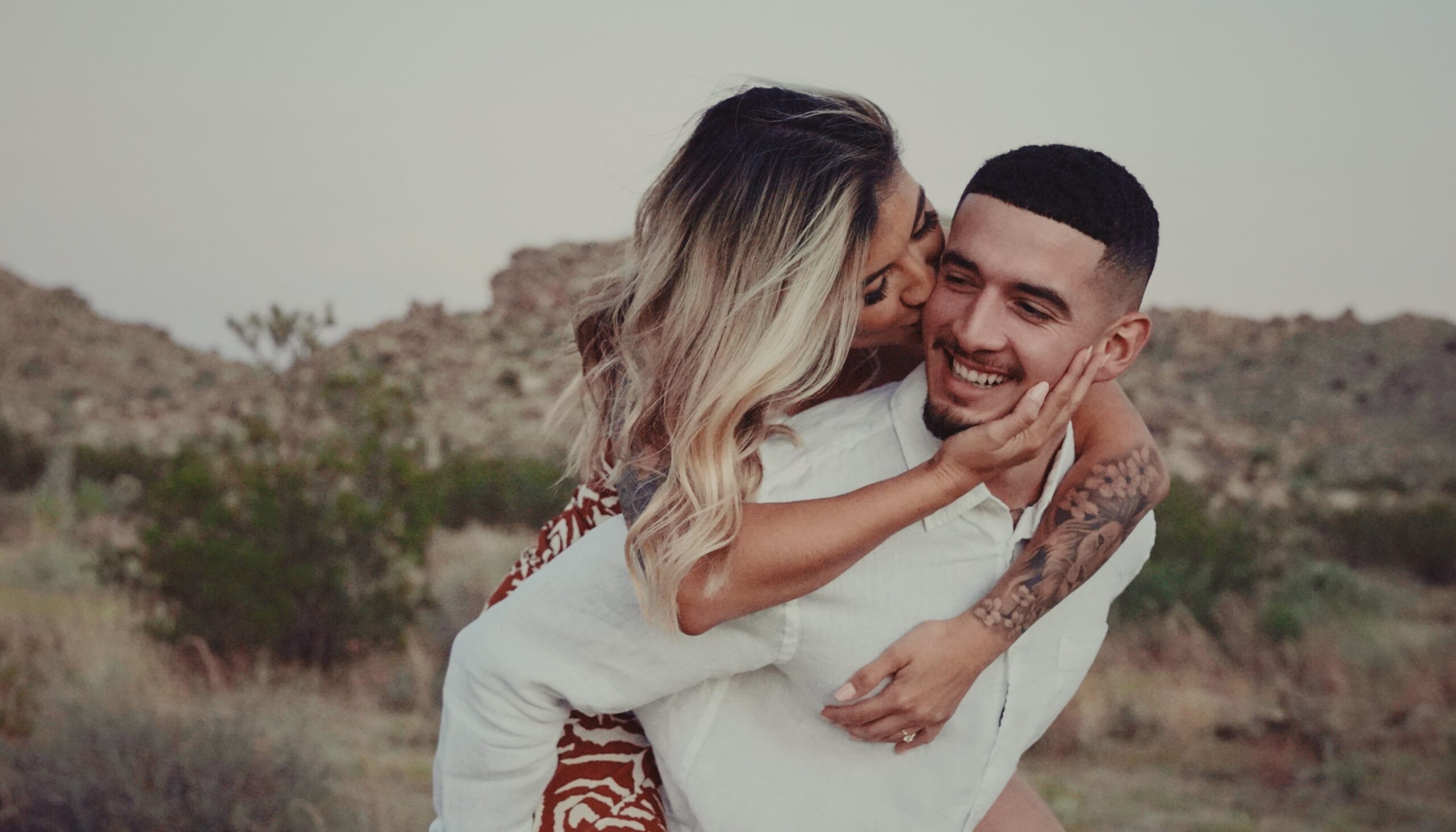 A couple who just got engaged taking photos in the mountains of California.