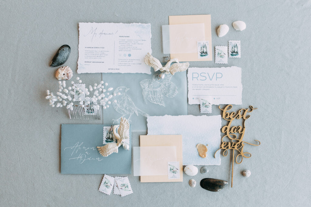 Stylish printing at the wedding ceremony, beautiful details and decor with flowers and rings. Wedding and bridal luncheon invitations made by hand with calligraphy
